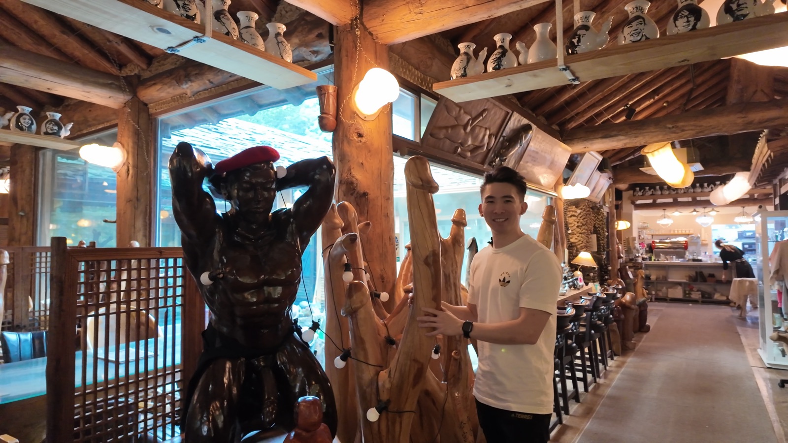 Vincent posing with the wooden carvings at Deulmusae