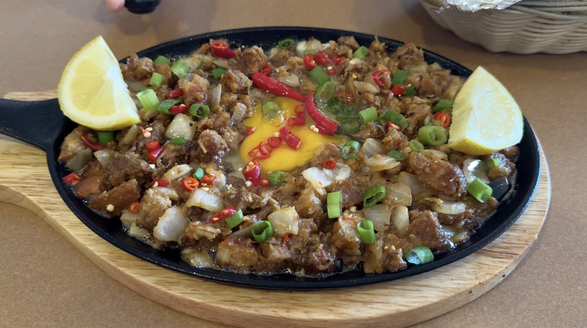 Sizzling sisig with egg and chili at At My Place Cafe