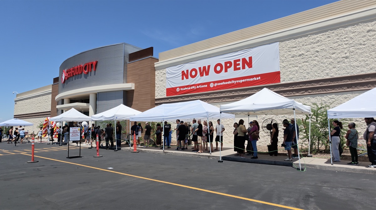 Line outside the Seafood City Chandler entrance on grand opening day with a Now Open banner