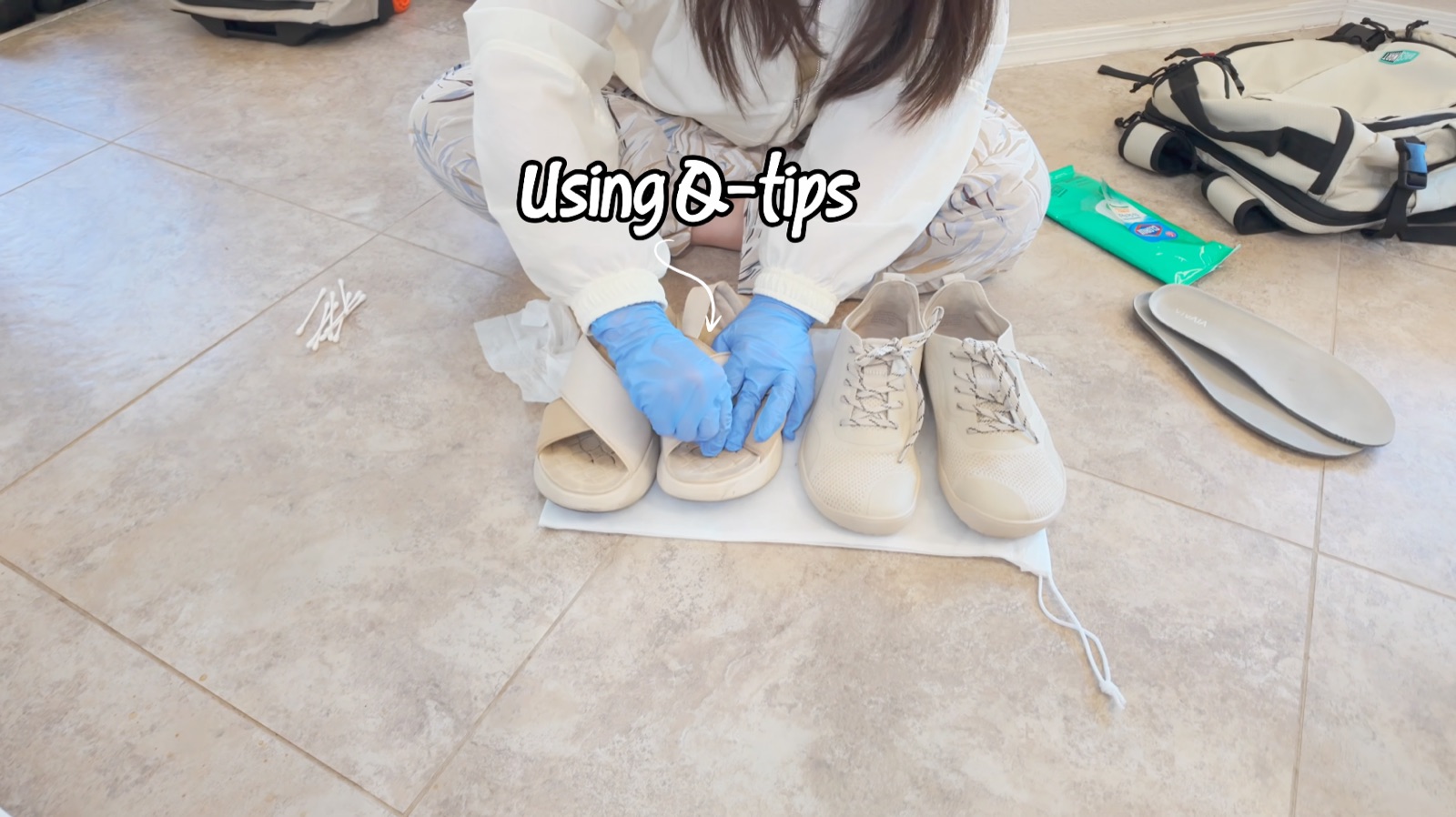 Using a Q-tip to clean the footbed grooves of the Vivaia shoes