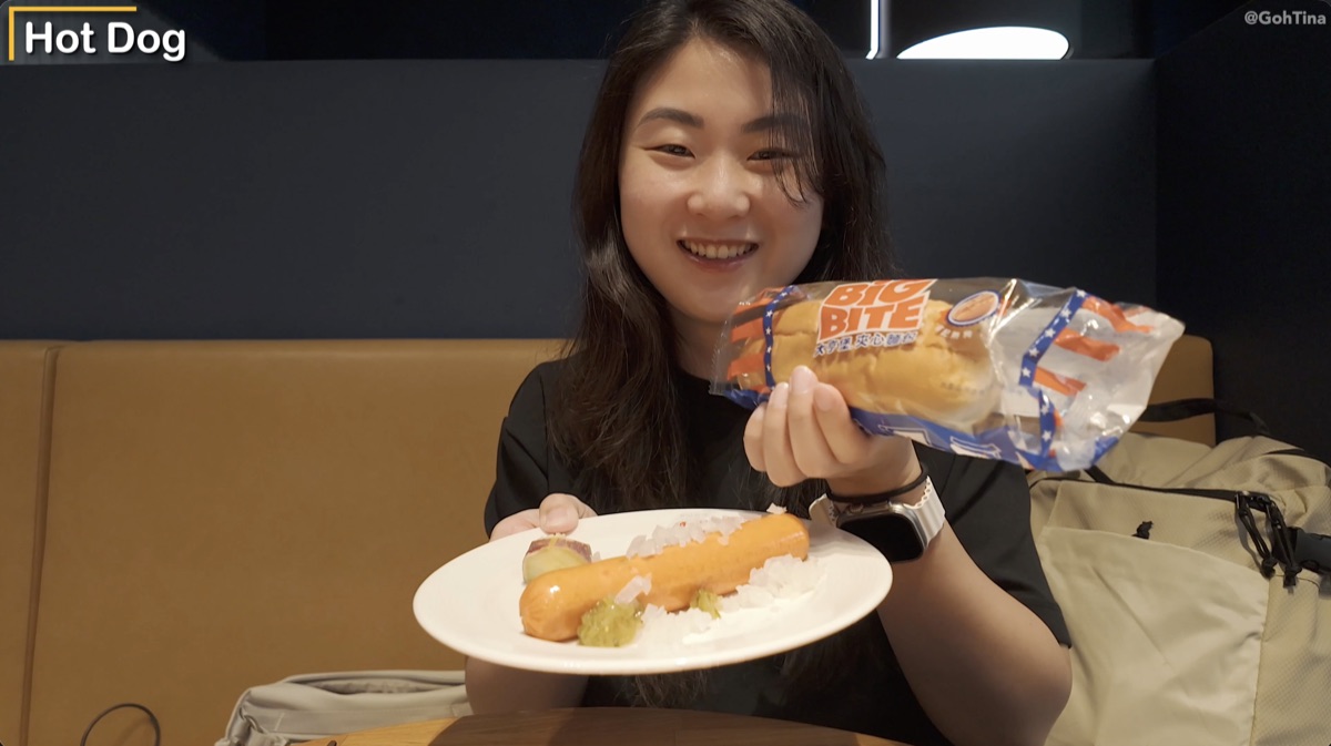Eating the assembled American hot dog at the Starlux Galactic Lounge