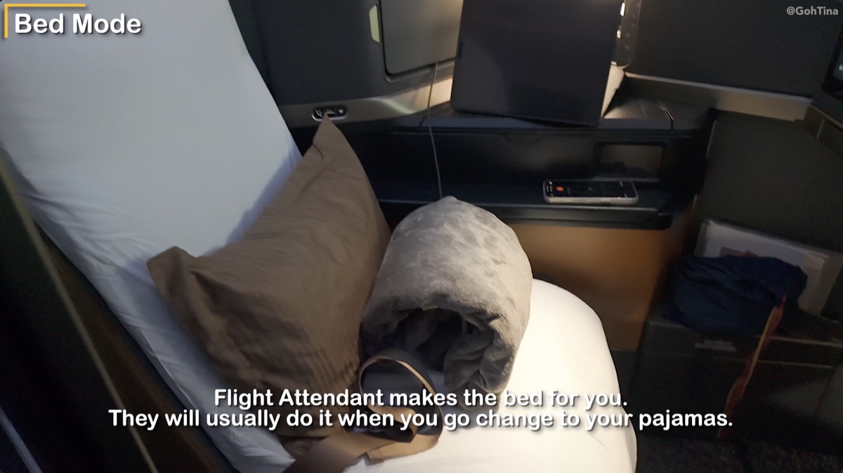 Flight attendant making the bed in Starlux business class