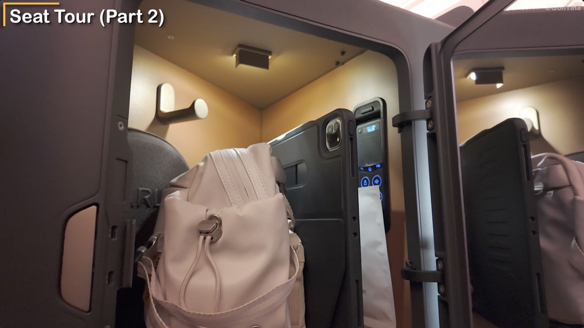 Large Starlux business class storage compartment fitting a sling bag and iPad