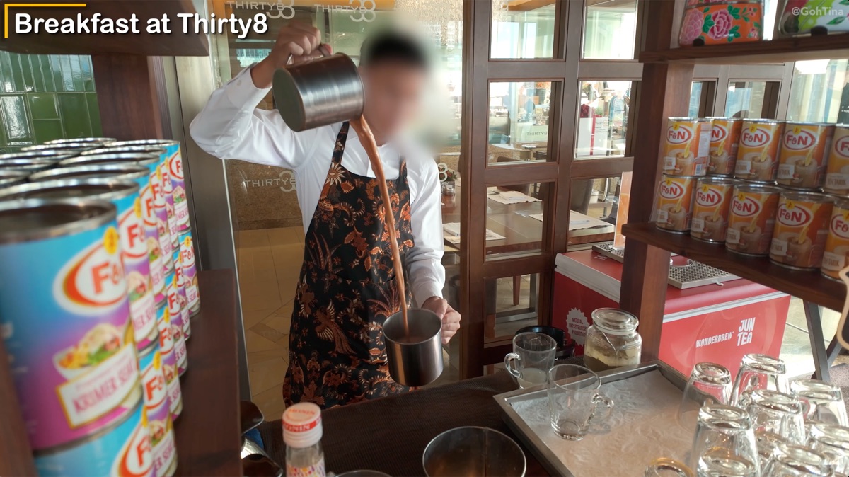 Staff performing the teh tarik pulling technique