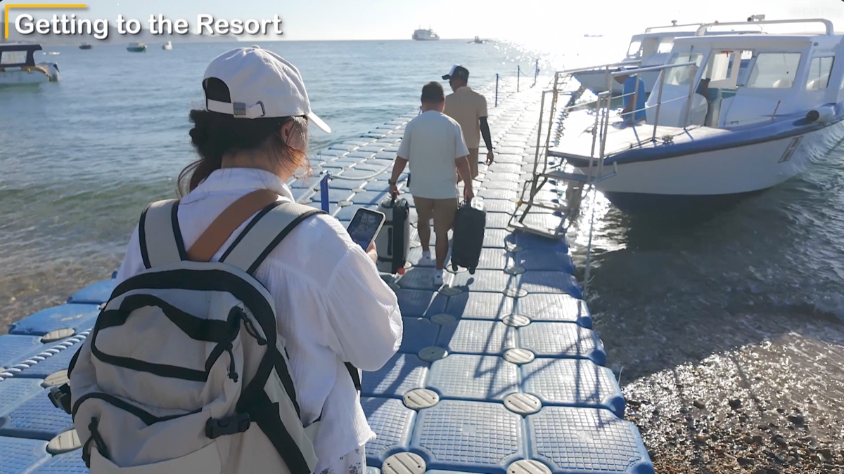 Staff taking our luggage as we walk to the boat