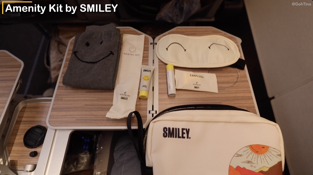 Starlux premium economy amenity kit with eye mask, socks, toothbrush, and chapstick