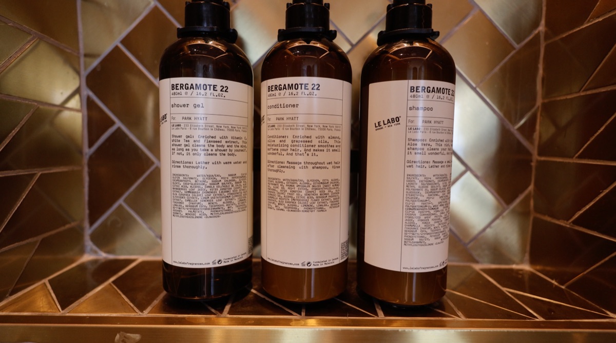 Branded shower gel, shampoo, and conditioner in the bathroom