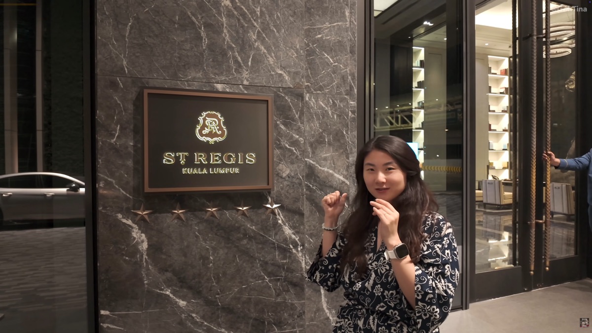 Posing in front of the St. Regis Kuala Lumpur sign at the entrance