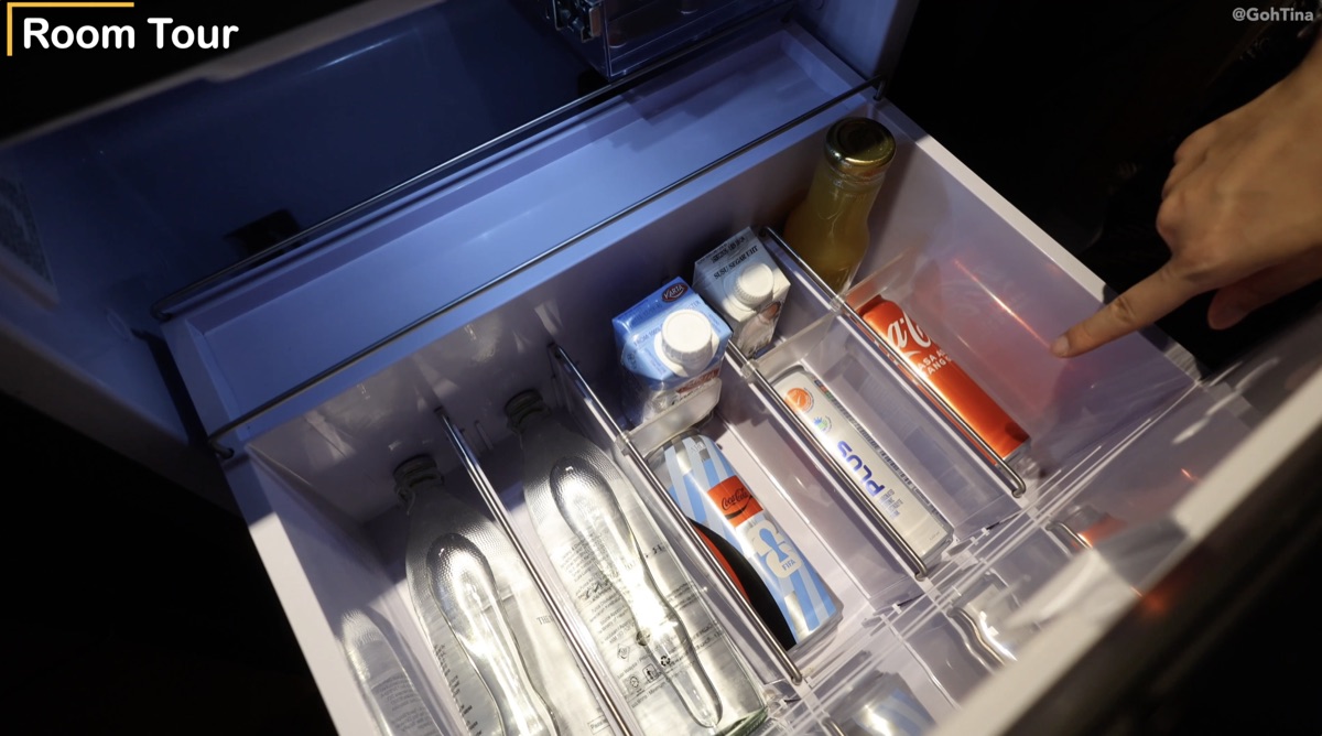 Complimentary fridge drinks including Coca-Cola, 100 Plus, and coconut water